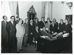 Carl Albert is seated beside Polish First Secretary Edward Gierek during his visit to the U.S. Behind them is standing a large group including Dan Rostenkowski and Clement Zablocki. October 9, 1974, 1974-10-09