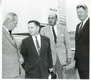 Carl Albert standing with three unidentified men at an airport during the trip to Bogota, Columbia., 1950-01-01 - 1976-12-31
