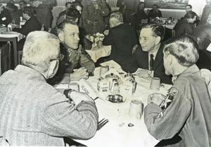 Carl Albert seated at a table with three other gentlemen during the trip to Korea., 1950-01-01 - 1976-12-31