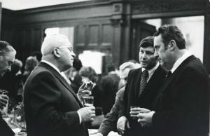 Carl Albert, Robert Michel, and several others seated at a conference table. House delegation trip. August 1975, 1975-08-04