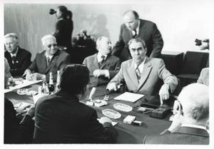Carl Albert, Melvin Price, Clement Zablocki, and others seated in a room during the House delegation trip to USSR, Romania, and Yugoslavia. August 1975, 1975-08-04