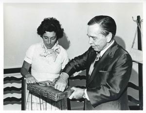 Carl Albert and Jan Lipsen trying to open a present., 1950-01-01 - 1976-12-31