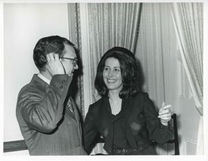 Carole Howard speaking to an unidentified man at her farewell party., 1950-01-01 - 1976-12-31