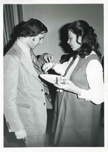 Jane England Lawton talking with an unidentified man at her farewell party on March 8, 1974, 1974-03-08