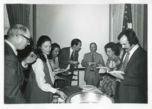 Charlie Ward, Jane England Lawton, Jan Lipsen, and others eating at Lawton&#39;s farewell party. March 8, 1974, 1974-03-08