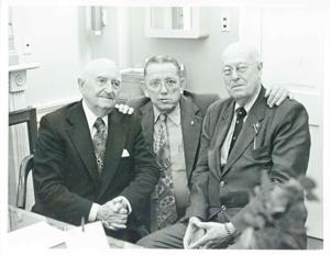 Three unidentified men seated and posing together., 1950-01-01 - 1976-12-31
