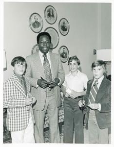 Hank Aaron signing autographs for three young boys., 1950-01-01 - 1976-12-31