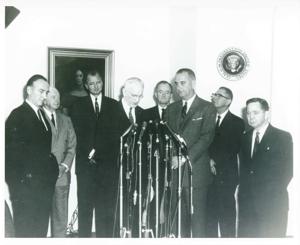 Mike Mansfield, Harry F. Byrd, John W. McCormack, Hubert H. Humphrey, Lyndon B. Johnson, Wilbur D. Mills, and Carl Albert standing in front of microphones. Same as photo 1698, 1950-01-01 - 1976-12-31