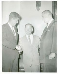 Carl Albert shaking hands with John F. Kennedy as an unidentified man looks on., 1950-01-01 - 1976-12-31