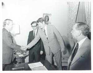 John Rhodes shaking hands with an unidentified man as Carl Albert looks on., 1950-01-01 - 1976-12-31
