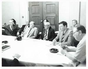 Melvin Price, Thomas E. Morgan, and several other men seated at a round table., 1950-01-01 - 1976-12-31
