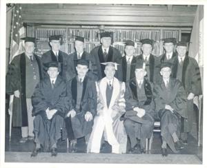 Several unidentified men posing for a photo. They are all wearing mortar boards and robes., 1950-01-01 - 1976-12-31