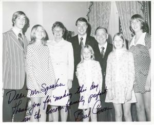 Carl Albert posing with Bill Connor and family. The inscription reads: Dear Mr. Speaker-Thank you for making this day in the Connor family perfect. Bill Connor., 1950-01-01 - 1976-12-31