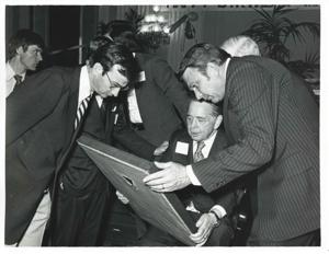 Carl Albert and two unidentified men looking at one of Albert&#39;s new presents., 1976-05-10