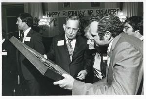 Carl Albert holding up his new portrait of Oklahoma football on his birthday. 1976, 1976-05-10