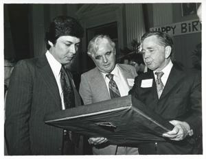 Carl Albert holding up his new portrait of Oklahoma football on his birthday. 1976, 1976-05-10