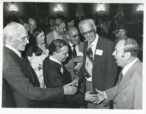 Carl Albert shaking hands with an unidentified man. John W. McCormack is also pictured., 1976-05-10