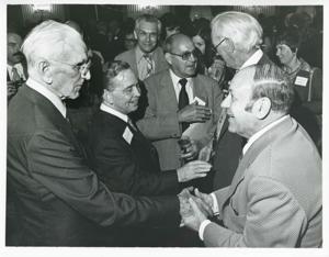 Carl Albert shaking hands with an unidentified man. John W. McCormack is also pictured., 1976-05-10