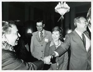 Carl Albert shaking hands with an unidentified man at his birthday party, 1976, 1976-05-10