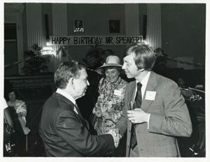 Carl Albert shaking hands with Bill Stephens. Bella Abzug is in the background at Albert&#39;s birthday party, 1976, 1976-05-10