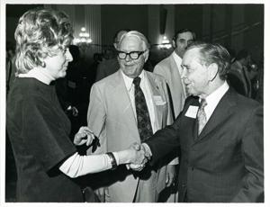 Carl Albert shaking hands with an unidentified woman at his birthday party, 1976, 1976-05-10