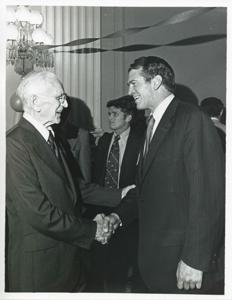 John W. McCormack shaking hands with an unidentified man at Carl Albert&#39;s birthday party, 1976, 1976-05-10