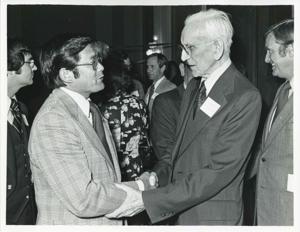 John W. McCormack shaking hands with an unidentified man at Carl Albert&#39;s birthday party, 1976, 1976-05-10