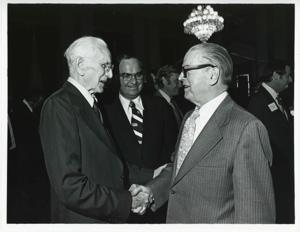 John W. McCormack shaking hands with an unidentified man at Carl Albert&#39;s birthday party, 1976, 1976-05-10