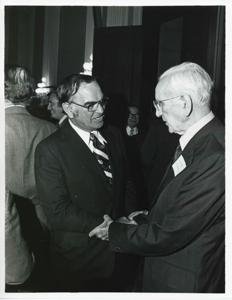John W. McCormack shaking hands with Congressman Joe Moakley from Massachusetts at Carl Albert&#39;s birthday party, 1976, 1976-05-10