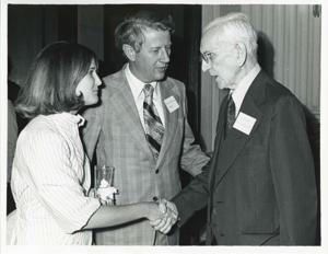 John W. McCormack shaking hands with an unidentified woman at Carl Albert&#39;s birthday party, 1976, 1976-05-10