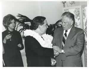 Carl Albert shaking hands with an unidentified man at his birthday party. May 10, 1974, 1974-05-10