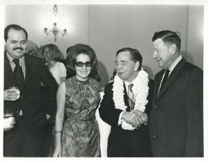 Carl Albert shaking hands with an unidentified man at his birthday party. May 10, 1974, 1974-05-10