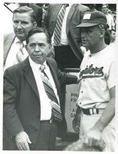 Carl Albert standing with an unidentified baseball player at the congressional game, 1972, 1972-01-01 - 1972-12-31