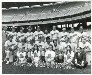 Carl Albert posing with congressional baseball team and cheerleaders. 1972, 1972-01-01 - 1972-12-31