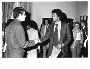 Arthur Ashe shaking hands with an unidentified man. 1975, 1975-01-01 - 1975-12-31