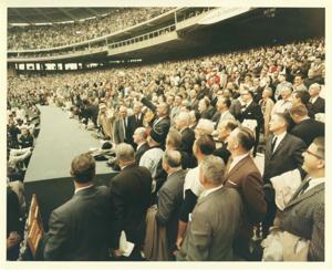 Lyndon B. Johnson throwing in the baseball at a baseball game. Also pictured is Charles Halleck, Everett Dirksen, Lyndon B. Johnson, Hale Boggs, Hubert Humphrey, Lawrence F. O&#39;Brien, George D. Aiken, John W. McCormack, and Carl Albert. 1964, 1964-01-01 - 1964-12-31
