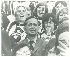 Carl Albert seated in the stands with band members from the University of Oklahoma., 1950-01-01 - 1976-12-31
