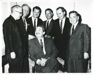 Tom Steed, A. S. Mike Monroney, Jed Johnson, Jr., John Jarman, Ed Edmondson, and Carl Albert, standing behind Thomas Jefferson De Benning? who is seated., 1950-01-01 - 1976-12-31