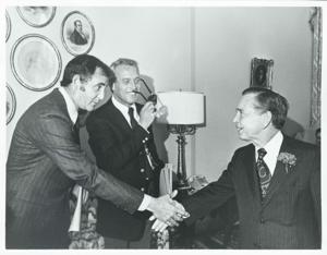Carl Albert shaking hands with an unidentified person., 1976-02-04