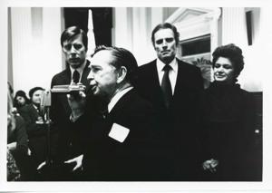 Carl Albert speaking into a microphone. Charlton Heston is standing behind him., 1950-01-01 - 1976-12-31
