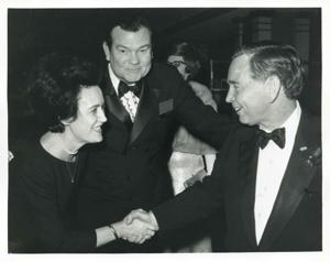 Carl Albert shaking hands with an unidentified woman as Tom Daniel looks on., 1950-01-01 - 1976-12-31