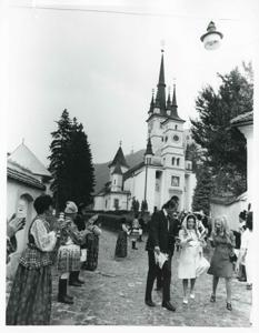 Mary Albert walking down the street with several other people., 1975-08-04