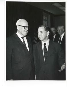 Carl Albert speaking with an unidentified man. Wright Patman is in the background., 1950-01-01 - 1976-12-31