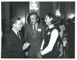 Carl Albert speaking with an unidentified man and woman at the reception for freshman members of the 94th Congress. December 1, 1975, 1975-12-01