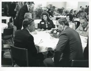 Carl Albert speaking with an unidentified man at the reception for freshman members of the 94th Congress. December 1, 1975, 1975-12-01