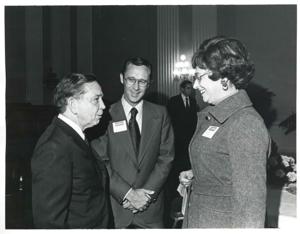 Carl Albert speaking with two unidentified people at a reception honoring freshman members of the 94th Congress. December 1, 1975, 1975-12-01