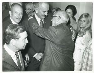 Lyndon B. Johnson shaking hands with an unidentified man. Carl Albert and others are pictured., 1950-01-01 - 1976-12-31