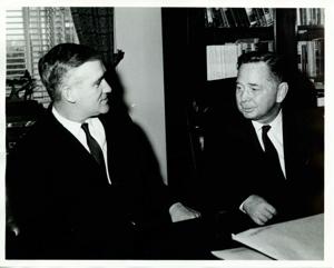 Carl Albert seated at his desk with unidentified man., 1950-01-01 - 1976-12-31