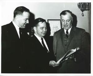 Ed Edmondson, Carl Albert, and Michael J. Kirwan looking at a book., 1950-01-01 - 1976-12-31