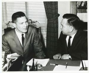 Carl Albert seated at his desk. An unidentified man is seated beside him., 1950-01-01 - 1976-12-31